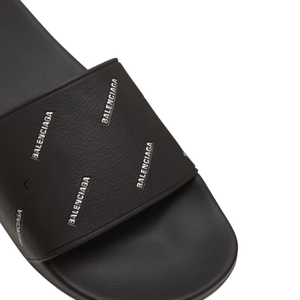 Balenciaga pool slides with allover logo lettering at the vamp